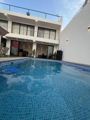 a large swimming pool in front of a building at Casa LeBlanc in Ica