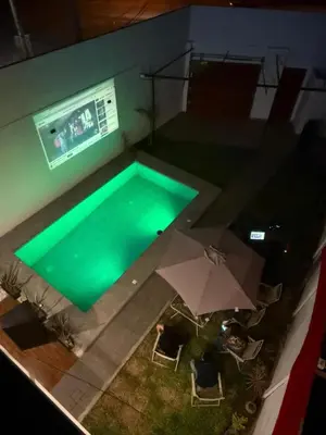 an overhead view of a pool with an umbrella and chairs at Casa LeBlanc in Ica