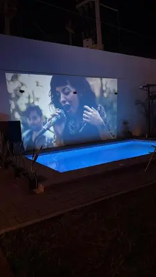 a large screen television with a woman on it at Casa LeBlanc in Ica