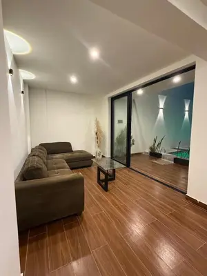 a living room with a couch and a glass table at Casa LeBlanc in Ica