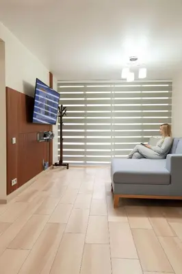 a woman sitting on a couch in a living room at Costanera Tourist Free Parking 3B 708 in Lima