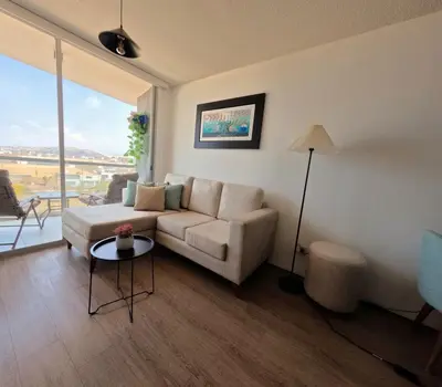 a living room with a couch and a table at Apartamento nuevo en San Bartolo con vista al mar in San Bartolo