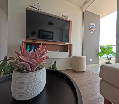a living room with a vase on a table at Apartamento nuevo en San Bartolo con vista al mar in San Bartolo