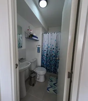 a bathroom with a toilet and a sink and a shower at Apartamento nuevo en San Bartolo con vista al mar in San Bartolo