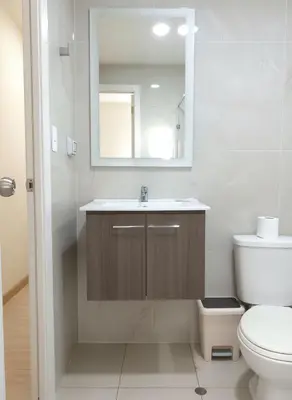 a bathroom with a sink and a toilet and a mirror at E SuiteCost FreeParking San Miguel 1B 708 in Lima