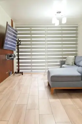 a living room with a couch and a television at E SuiteCost FreeParking San Miguel 1B 708 in Lima