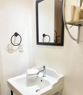 a white bathroom with a sink and a mirror at E Free Parking Patio Privado Barranco 1B 109 in Lima