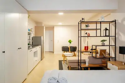 a kitchen and living room with white cabinets and a room at E Free Parking Patio Privado Barranco 1B 109 in Lima