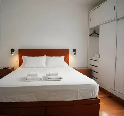 a bedroom with a white bed with two towels on it at E Larcomarzone FamilyTourist Laundry 3B 503 in Lima