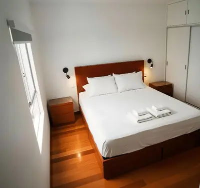 a bedroom with a bed with two towels on it at E Larcomarzone FamilyTourist Laundry 3B 503 in Lima