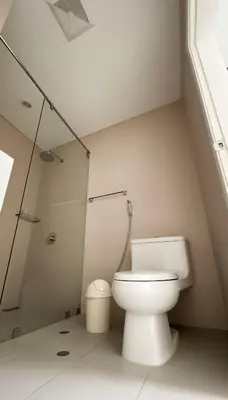 a white bathroom with a toilet and a shower at E Larcomarzone FamilyTourist Laundry 3B 503 in Lima