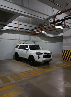 a white suv parked in a parking garage at E Suite Tourist free Parking Miraflores 1B 503 in Lima