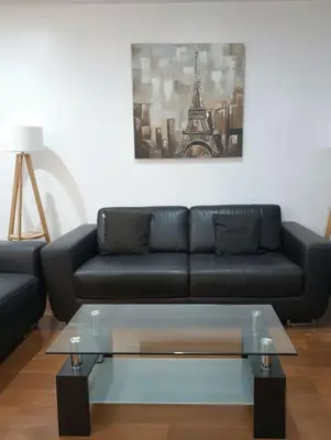 a living room with a black couch and a coffee table at E Suite Tourist free Parking Miraflores 1B 503 in Lima