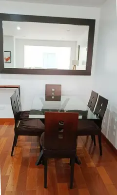 a dining room table with chairs and a glass top at E Suite Tourist free Parking Miraflores 1B 503 in Lima