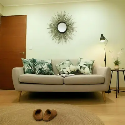 a living room with a couch with pillows and a mirror at E Free Parking Wifi Pro Laundry 1B 204 in Lima