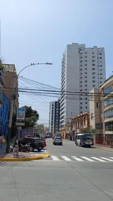 a city street with cars driving down a street with buildings at E Free Parking Wifi Pro Laundry 1B 204 in Lima