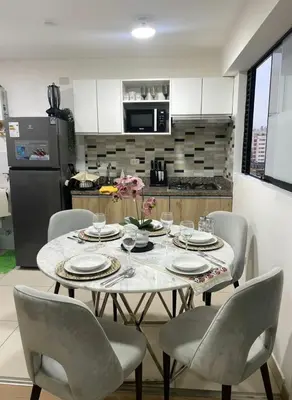 a dining room table with chairs and a kitchen at E Free Parking Wifi Pro Laundry 1B 204 in Lima