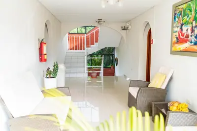 a living room with chairs and a staircase at Valle Hermoso in San Ramón