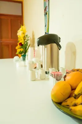 a plate of bananas on a counter with flowers at Valle Hermoso in San Ramón