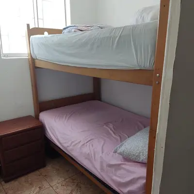 a bunk bed in a small room with a mattress at La Palmera Apartment in San Bartolo