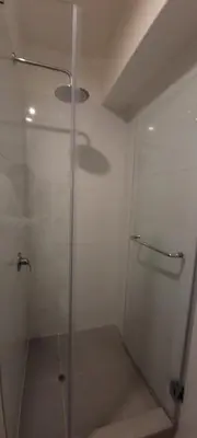 a shower with a glass door in a bathroom at Loft de Luxe - cerca a San Borja & San Isidro in Lima
