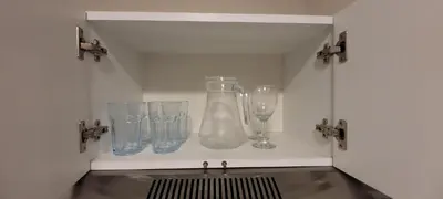 a shelf with glasses and a vase on it at Loft de Luxe - cerca a San Borja & San Isidro in Lima