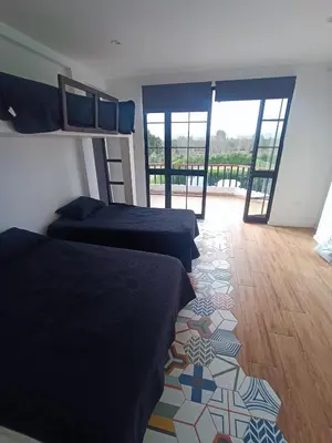 a bedroom with two beds and a tile floor at Hermosa casa con piscina privada in Asia