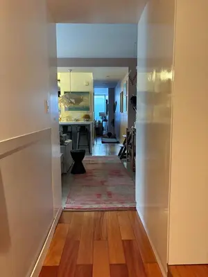 a hallway leading into a kitchen with a living room at Huaca Pucllana Design Apartment between Miraflores and San Isidro in Lima