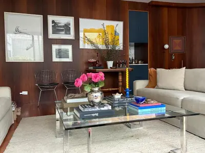 a living room with a glass table with flowers on it at Huaca Pucllana Design Apartment between Miraflores and San Isidro in Lima