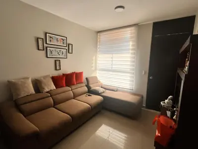 a living room with a brown couch and a window at Casa privada y acogedora en Ica con Parking in Ica