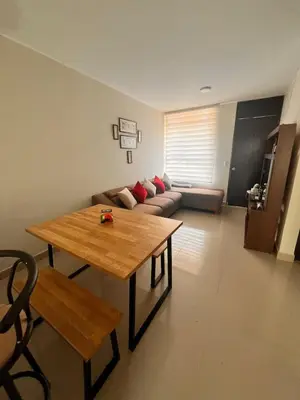a living room with a table and a couch at Casa privada y acogedora en Ica con Parking in Ica