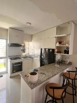 a kitchen with white cabinets and a granite counter top at Casa privada y acogedora en Ica con Parking in Ica