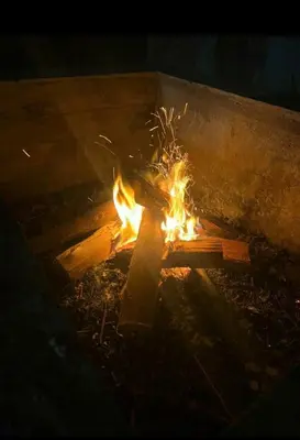 a cross on fire in a fire pit at night at Casa de campo Cieneguilla Vista Bonita in Cieneguilla