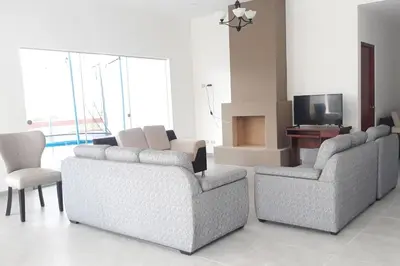 a living room with two couches and a television at Casa de campo Cieneguilla Vista Bonita in Cieneguilla