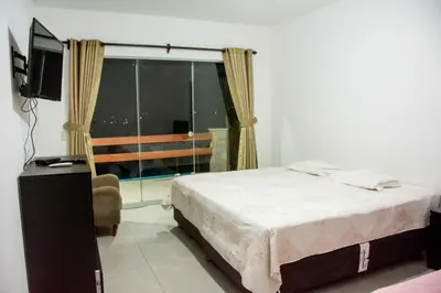 a bedroom with a bed and a tv and a window at Casa de campo Cieneguilla Vista Bonita in Cieneguilla