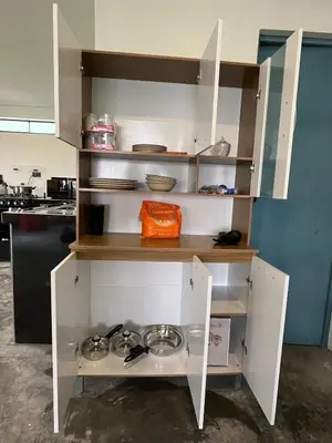 a kitchen with white cupboards with bowls and plates at House with a panoramic view of the city and mountains in San Miguel