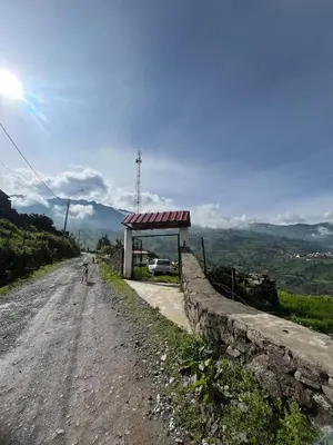 a person riding a bike down a dirt road at House with a panoramic view of the city and mountains in San Miguel