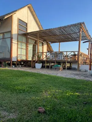 a house with a roof with a grass yard at Refugio 55 Casa de Playa en Chincha, Frente al mar in Chincha Baja