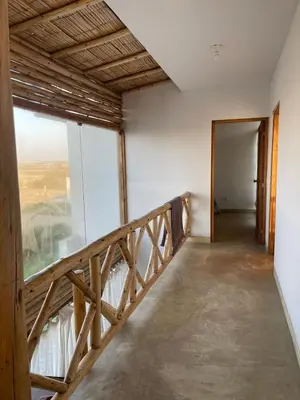 a room with a balcony with a wooden stairway at Refugio 55 Casa de Playa en Chincha, Frente al mar in Chincha Baja
