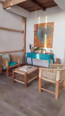 a room with a blue table and wicker chairs at Refugio 55 Casa de Playa en Chincha, Frente al mar in Chincha Baja