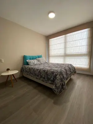 a bedroom with a bed and a table and a window at Life is better by the sea in Lima