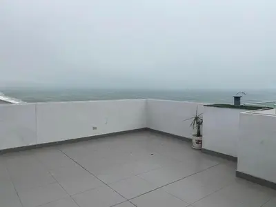 a balcony with a view of the ocean at Life is better by the sea in Lima