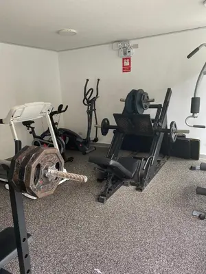 a gym with two exercise bikes and a treadmill at Life is better by the sea in Lima