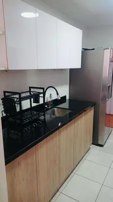 a kitchen counter with a sink and a refrigerator at Casa Lima Brasil in Lima