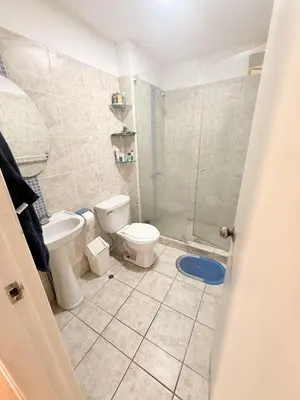 a bathroom with a toilet and a glass shower at Casa Lima Brasil in Lima