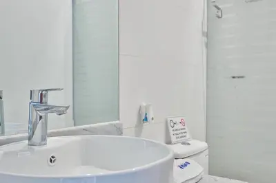 a white bathroom with a sink and a toilet at Barranco Bright apartment with Balcony in Lima