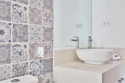 a bathroom with a white sink and a toilet at Barranco Bright apartment with Balcony in Lima