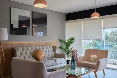 a living room with a couch and two chairs and a table at Barranco Bright apartment with Balcony in Lima