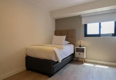 a small bedroom with a bed and a window at Marvelous 2BR with Balcony in Miraflores in Lima