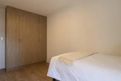 a bedroom with a bed and a wooden cabinet at Marvelous 2BR with Balcony in Miraflores in Lima